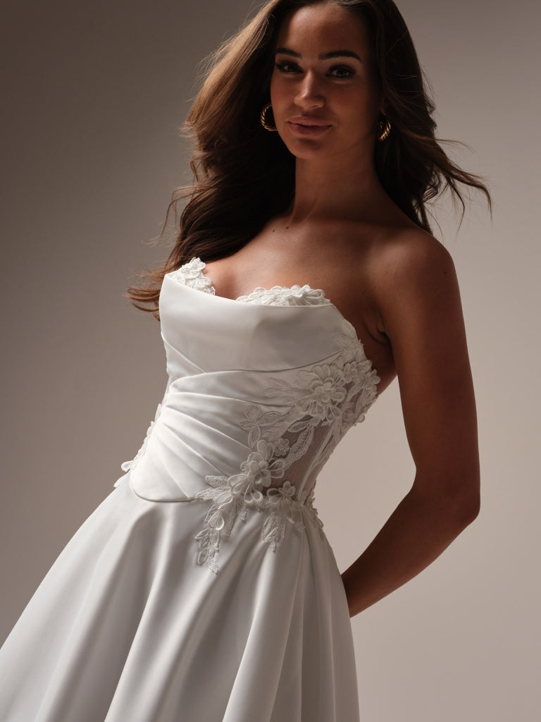 wedding dress with peekaboo lace Swooning off this gorgeous and customizable, Mikado sheath gown. It features a detachable train and is accented with beaded and sequined lace, both along the peekaboo sweetheart neckline and detachable off-shoulder sleeves
