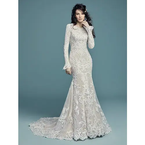 Lace motifs cascade over netting and tulle in this unique fit-and-flare modest wedding gown. Featuring a crew neckline, subtle V-back and long sleeves accented in bell cuffs. Lined with shapewear for a flattering fit, and zipper closure. #utahbridalshop #modestweddingdress #modest #longsleeves #bridalshop #bridalcloset #weddinggown #bride #lacegown #weddingdress #templeready 