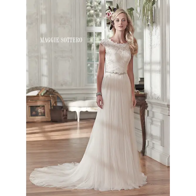Comprised of barely-there tulle, this stunning sheath wedding gown sparkles with a delicate Swarovski crystal belt at the waist. Lace neckline cap-sleeves crystal buttons #utahbridalshop #weddinggowns #sandyutah #bridalcloset #brides #bridalshop #utahwedding #designerweddings #templeready #weddingaccessories #modestweddingdress