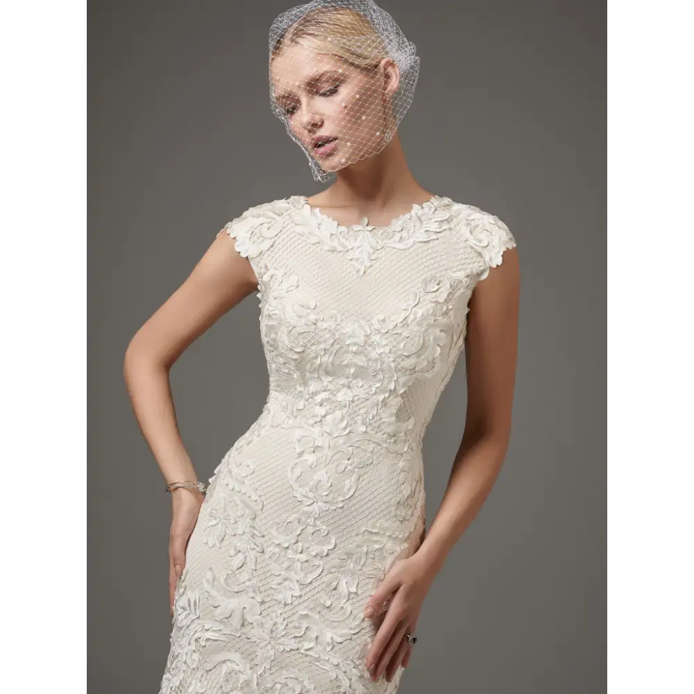 This dynamic team boasts three generations of experienced talent working together to direct the design activities of the Sottero & Midgley collection. Fit and flare features laser cut lace over textured netting jewel neckline modest cap sleeves #utahbridalshop #weddinggowns #sandyutah #bridalcloset #brides #bridalshop #utahwedding #designerweddings #templeready #weddingaccessories #modestweddingdress