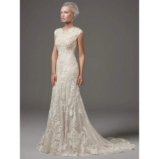 This unique and glamorous fit-and-flare features laser-cut lace over textured netting and Viva jersey lining with a jewel neckline and modest cap-sleeves trimmed with lace appliqués. Finished with zipper closure. Sottero & midgley collection stunning fashion design #utahbridalshop #weddinggowns #sandyutah #bridalcloset #brides #bridalshop #utahwedding #designerweddings #templeready #weddingaccessories #modestweddingdress
